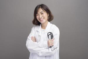 Portrait de jeune femme confiante médecin isolé sur fond gris studio photo