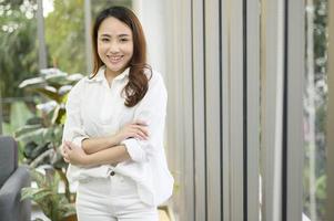 Portrait of business asian woman wearing white shirt in office photo