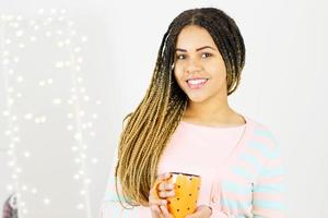femme afro-américaine souriante sexy sur fond de bokeh à la maison. fille aux dents blanches photo