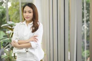 Portrait of business asian woman wearing white shirt in office photo