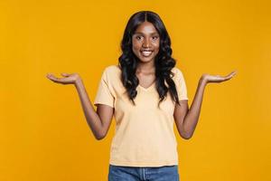 femme africaine positive étendant ses mains sur les côtés photo