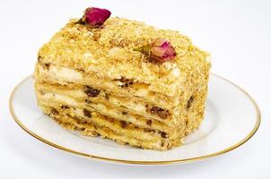 morceau de gâteau feuilleté fait maison avec de la crème sur une plaque blanche. photographie de studio photo