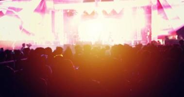 silhouettes de la foule du concert à la vue arrière de la foule du festival levant les mains sur les lumières de la scène photo