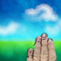 famille heureuse de doigt sur le fond vert de nature photo