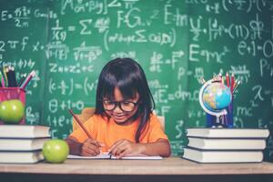 fille avec dessin au crayon à la leçon en classe photo