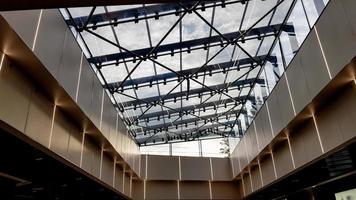 ukraine, kiev - 24 septembre 2019. vitrage structurel de la façade. fond abstrait avec des éléments de plafond en verre dans un bâtiment moderne. vue sur le ciel bleu à travers une fenêtre en verre. photo