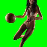 joueur de basket-ball femme tenant le ballon sur chromakey amovible vert photo