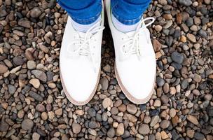 pieds de femmes en chaussures de ville, debout sur les pierres. photo