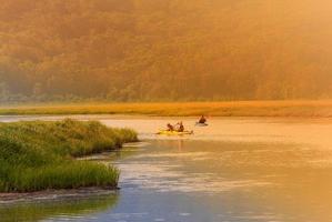 quelques kayaks sur un lac au coucher du soleil photo