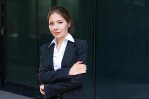 jeune femme d'affaires en costume près d'un immeuble de bureaux photo