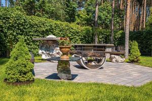 Foyer en fer avec banc sur pavé de pierre dans le jardin arrière-cour photo