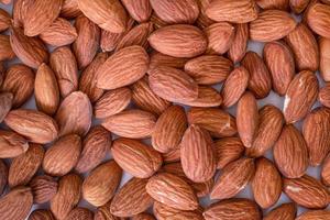 fond de grosses amandes pelées crues situées arbitrairement photo