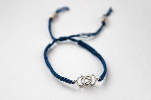 bracelet tressé bleu avec chakra ajna sur fond blanc photo