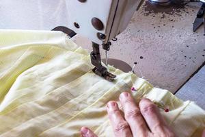 image les mains des femmes de couturière travaillant sur la machine à coudre. photo