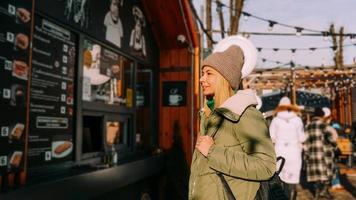 femme à la foire alimentaire choisit la nourriture d'un menu photo