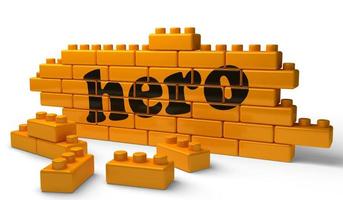 mot de héros sur le mur de briques jaunes photo