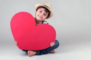 enfant heureux avec un coeur rouge photo