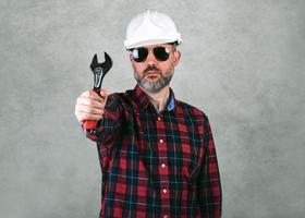 homme, ouvrier construction, à, a, casque blanc, et, lunettes soleil, tenue, a, clé photo