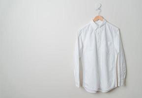 chemise suspendue avec cintre en bois au mur photo