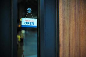 signe de gros plan avec du texte ouvert accroché à l'entrée du restaurant photo