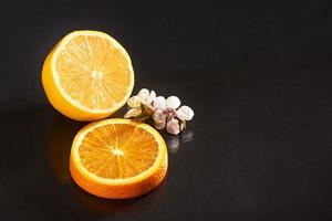 orange et citron délicieux et juteux isolés sur fond noir. photo