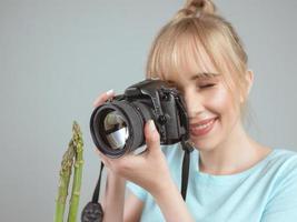 photographe de jeune femme tirant une asperge avec un appareil photo numérique. gros plan, tir, passe-temps, concept de profession