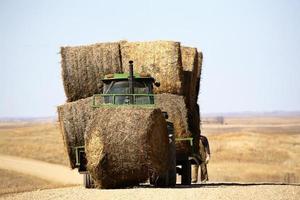 tracteur avec des balles de foin au début du printemps photo