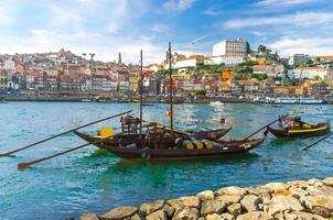 dessin à l'aquarelle du portugal, paysage de la ville de porto, bateaux en bois avec tonneaux de port de vin sur le fleuve douro, vue panoramique sur la vieille ville de porto photo