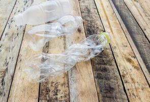 bouteilles d'eau en plastique à recycler sur la table en bois photo