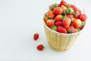 fraises fraîches dans un panier sur fond blanc photo