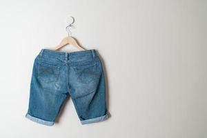 pantalon court jeans suspendu à un cintre photo