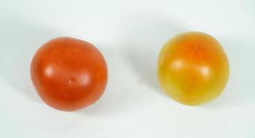 tomate fraîche verte et rouge sur fond blanc. photo