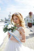 portrait d'une belle mariée blonde avec un bouquet. photo