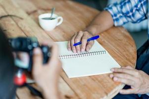 écrire sur papier au travail sur la table le matin, idées d'affaires. il y a de la place pour la copie. photo