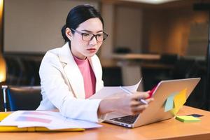 femme de travail élégante asiatique d'affaires de bureau avec des lunettes au bureau. photo