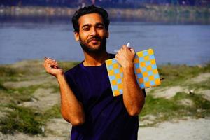 portrait d'un jeune étudiant souriant avec des livres et un sac à dos photo