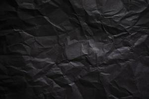 fond de papier noir froissé texturé. photo