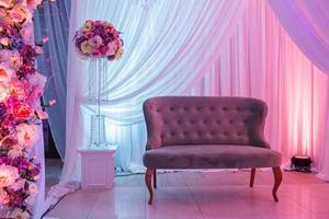décoration de mariage avec canapé rétro classique et fleurs blanches et roses. photo