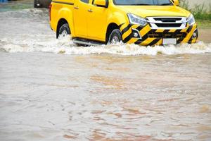 voiture de ramassage et véhicule dans les eaux de crue, assurance automobile et concept de situation dangereuse. photo