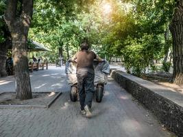 un homme pousse une charrette devant lui photo