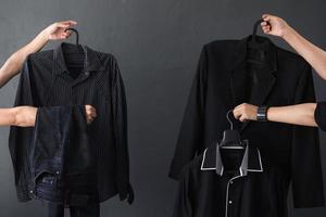 récolte de main offrant des vêtements noirs et des accessoires pour le concept de promotion de vente accro du shopping et du vendredi noir photo