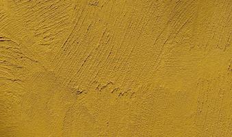 fond de texture de mur de plâtre jaune moutarde photo
