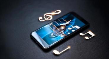 main abstraite jouant des notes de musique sur smartphone sur fond de nuit, concept musical photo