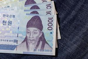 argent coréen, billet de banque coréen, won coréen sur fond de jean. photo