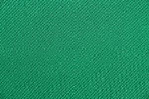 la texture de la couleur verte du tissu a une surface lisse, un fond abstrait. photo