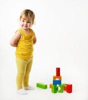 petite fille jouant avec des blocs de jouets colorés photo