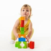 petite fille jouant avec des blocs de jouets colorés photo