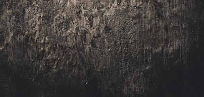 mur plein de rayures. texture de ciment grungy pour le fond, mur sombre effrayant. mur noir photo