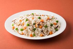 pulav indien ou légumes riz ou légumes biryani fond orange photo