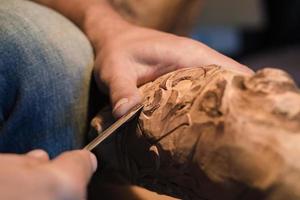 photo en gros plan d'un sculpteur sur bois au travail, artisanat avec du bois